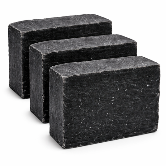 Three rectangular black soap bars on a white background