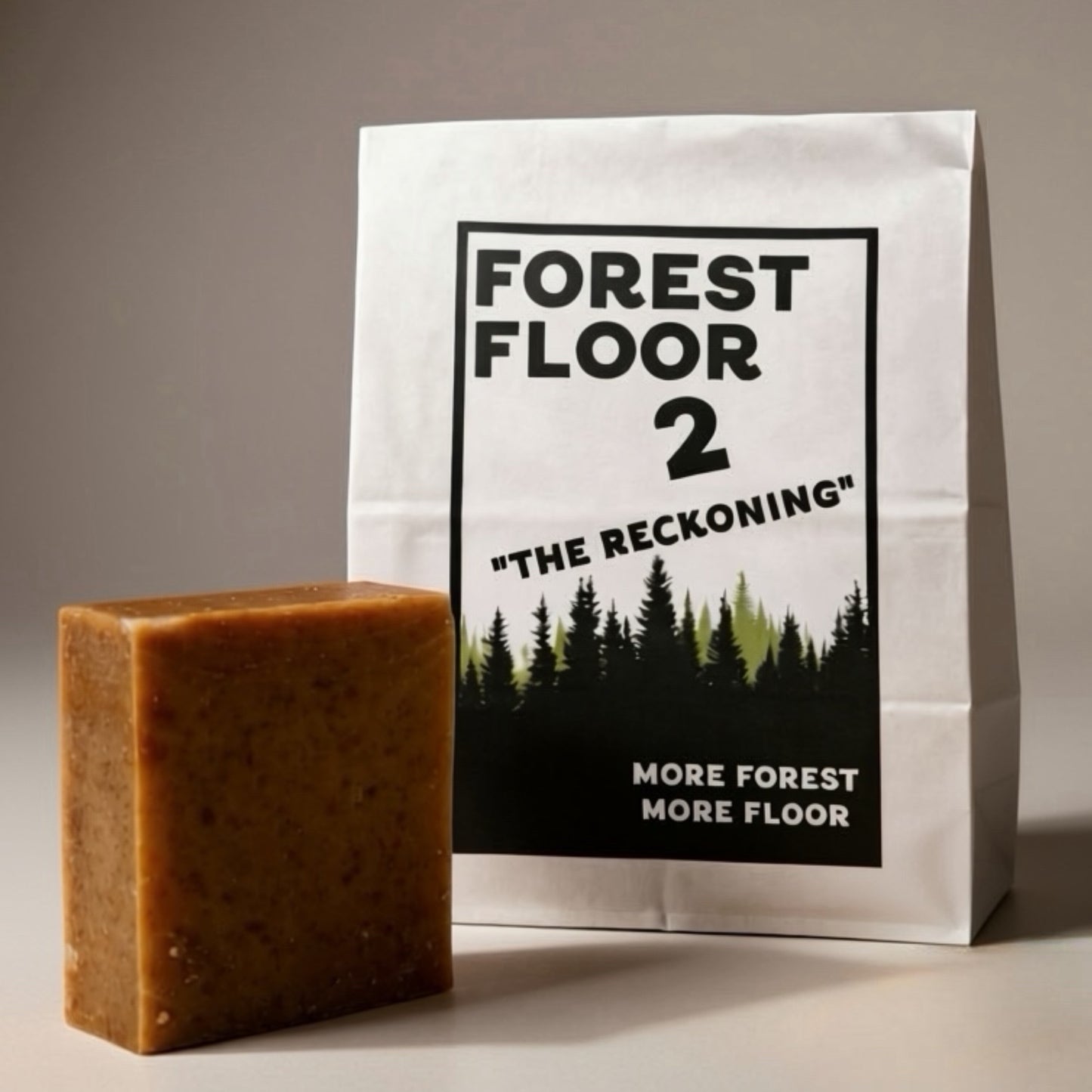 Bar of soap next to a packaging bag with 'Forest Floor 2' design on a neutral background