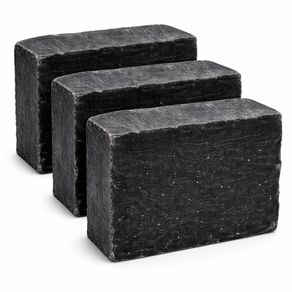 Three rectangular black soap bars on a white background