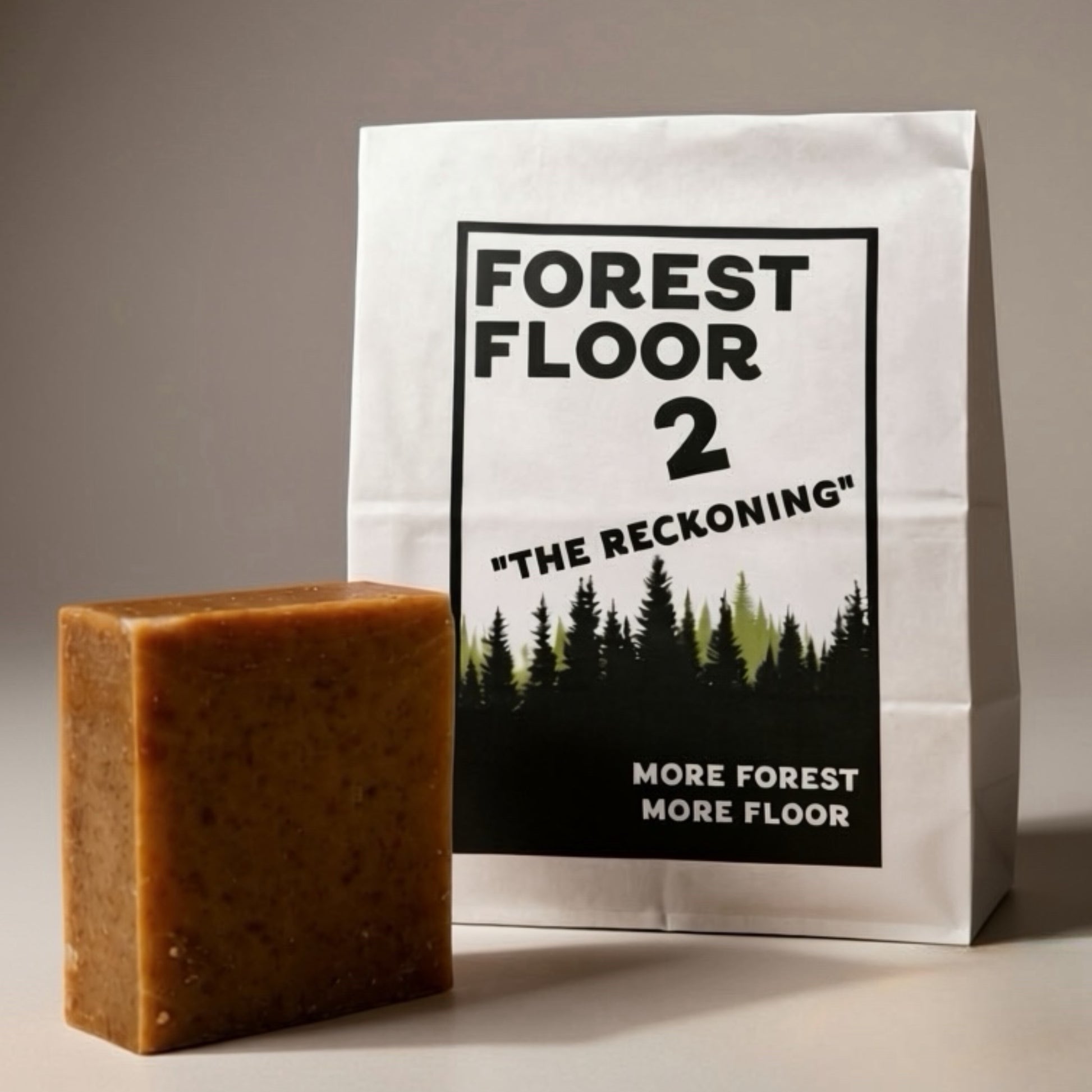 Bar of soap next to a packaging bag with 'Forest Floor 2' design on a neutral background