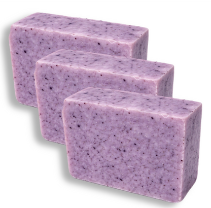 Three bars of purple soap with speckles on a white background