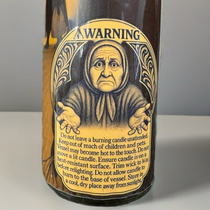 Bottle label with an illustration of an elderly woman and warning text on a gray background