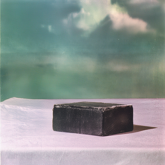 a black bar of soap sitting on a table
